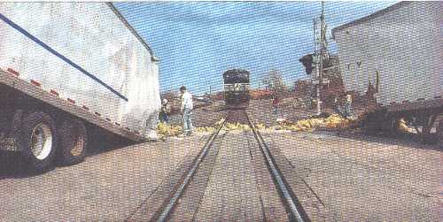 Semi-trailer cut in two by freight train